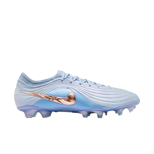 Side profile of a light blue Nike soccer cleat featuring a metallic copper swoosh, against a solid black background.
