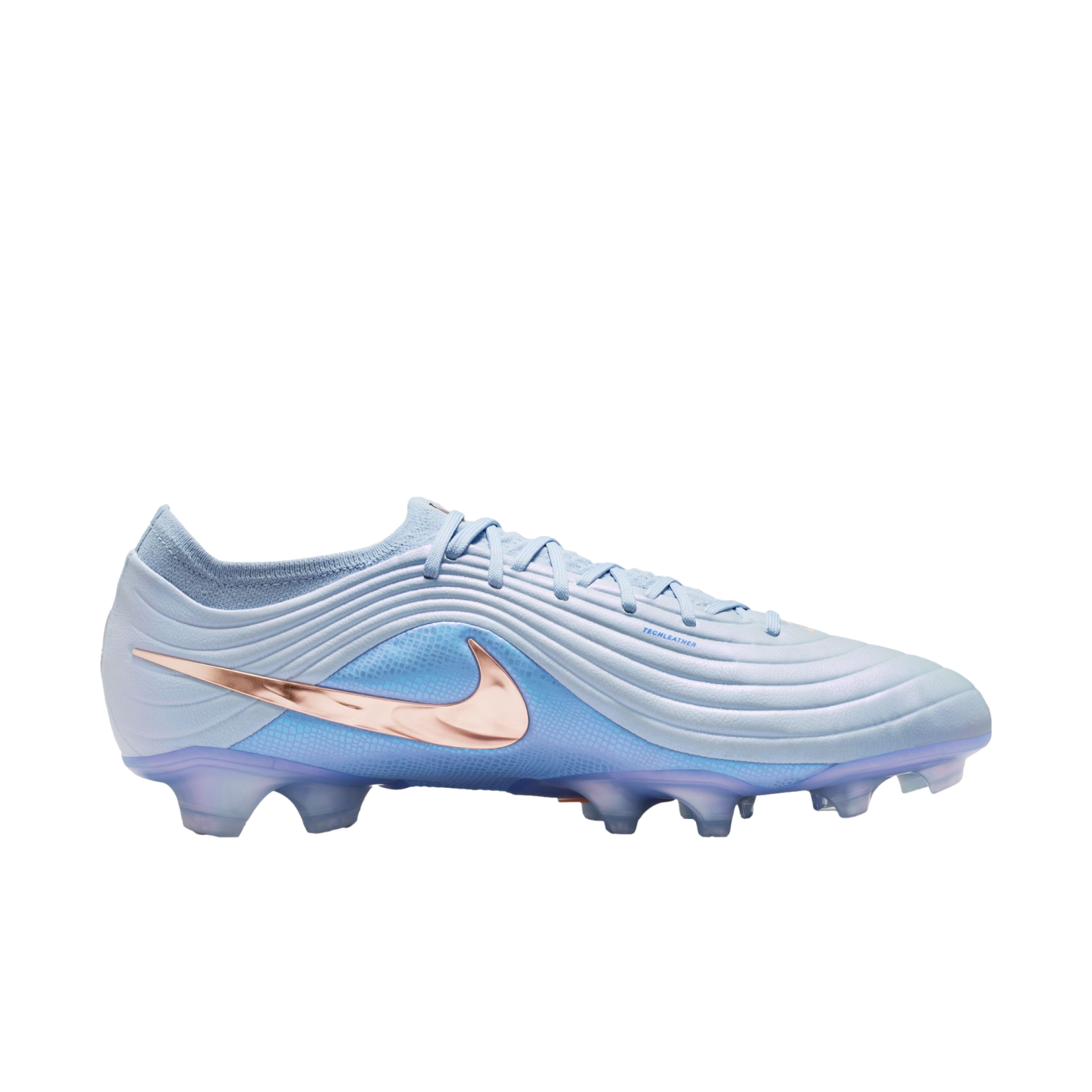 A light blue Nike soccer cleat featuring a metallic rose gold swoosh, textured upper, and translucent blue studs, set against a black background.