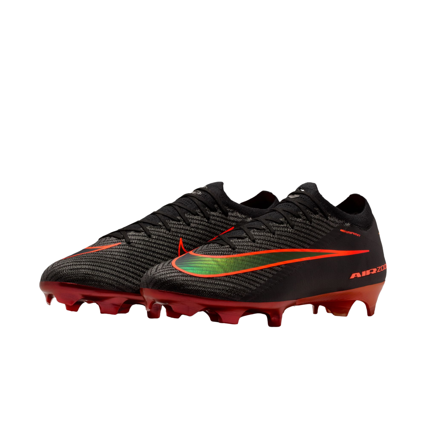 A pair of black Nike Air Zoom soccer cleats with red soleplates and a gradient green-to-orange Swoosh logo, shown against a solid black background.