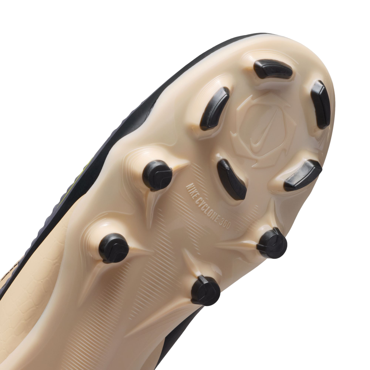 Close-up of a beige Nike soccer cleat's outsole with black studs and "NIKE CYCLONE 360" branding, shown against a solid black background.