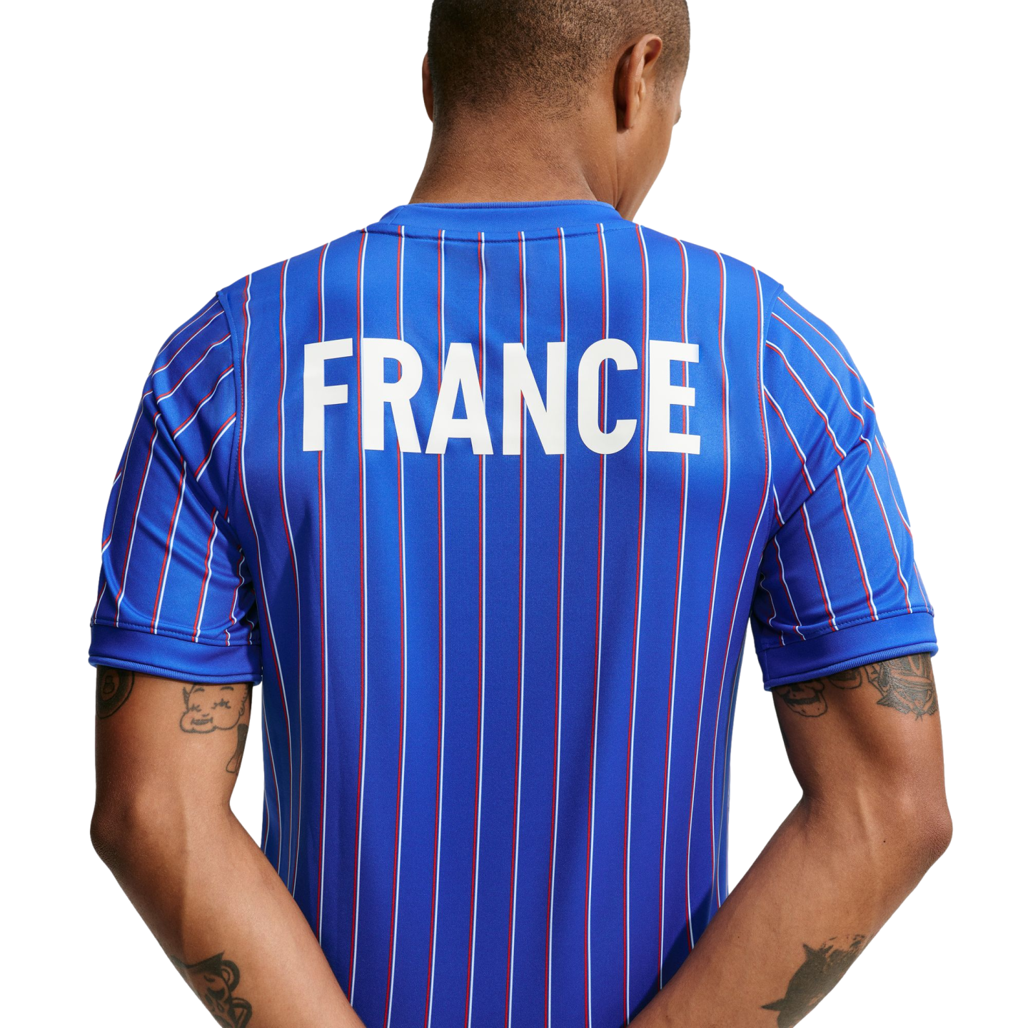 Rear view of a person wearing a blue jersey with thin red and white vertical stripes and "FRANCE" printed in large white letters on the upper back.