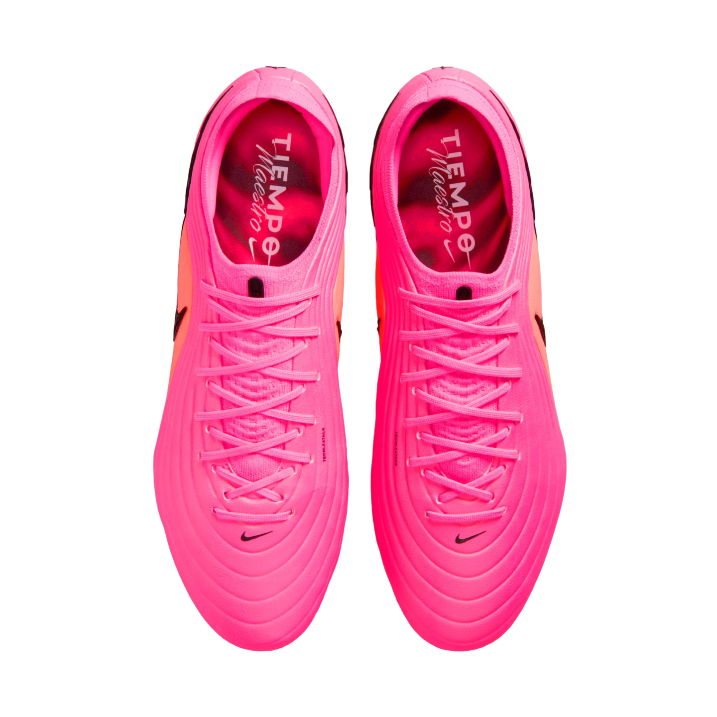 Top-down view of a pair of neon pink Nike Tiempo Maestro soccer cleats with matching pink laces and small black Nike swooshes.