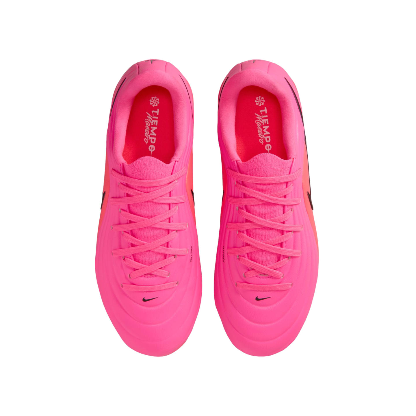A top-down view of a pair of vibrant pink Nike Tiempo Maestro soccer cleats against a white background.