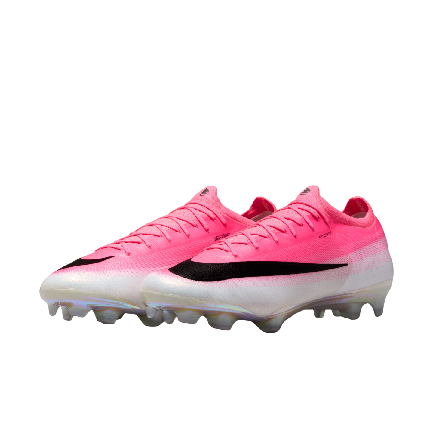 A pair of pink and white Nike soccer cleats with a large black swoosh and iridescent studs on a plain white background.