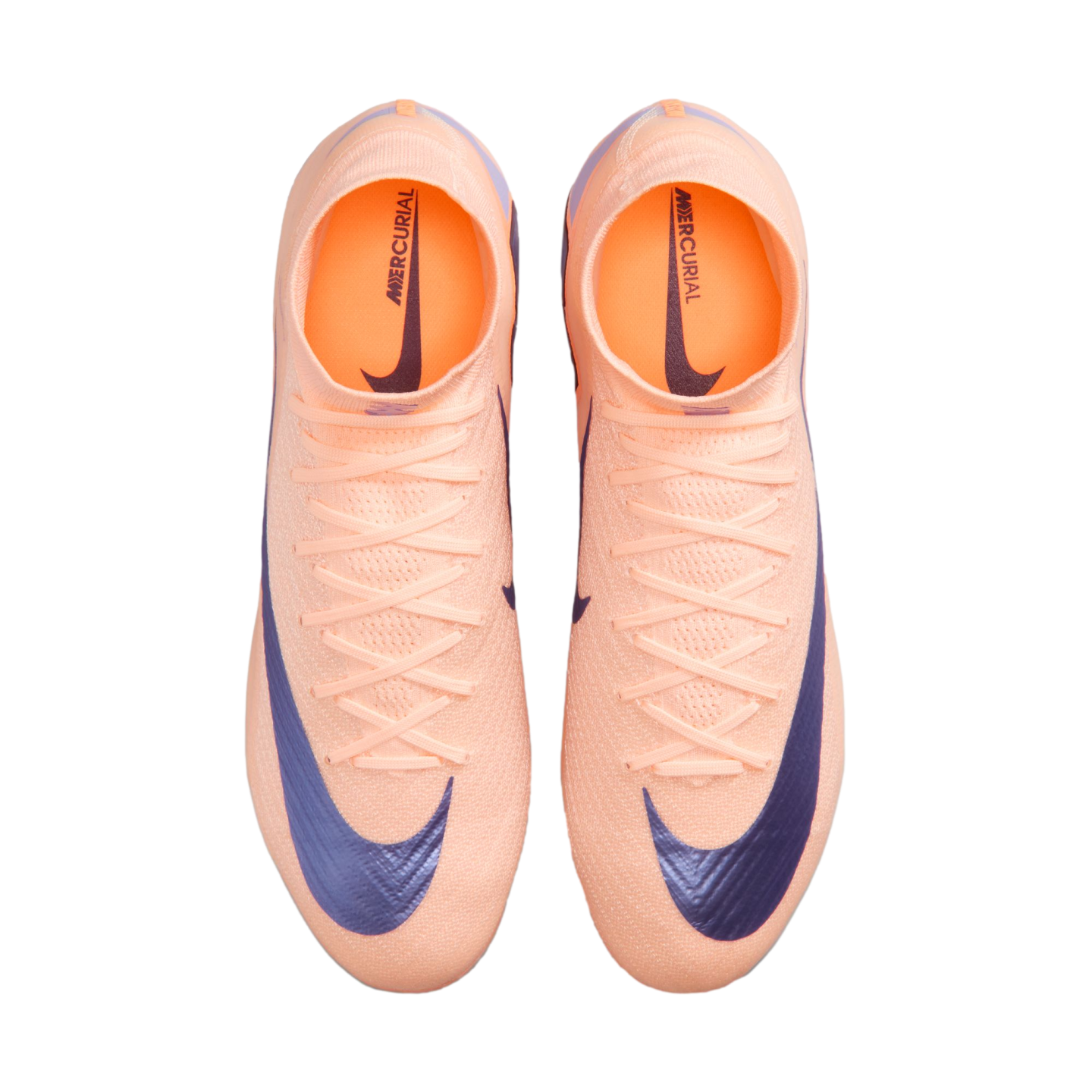 Top-down view of peach-colored Nike Mercurial soccer cleats with dark blue swooshes and high-top collars against a black background.