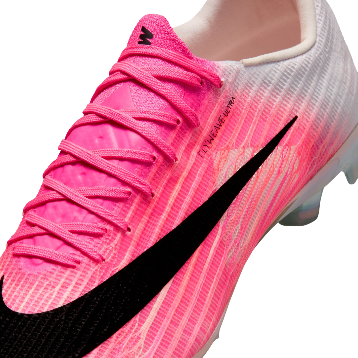 Close-up of a Nike Mercurial soccer cleat with a pink and white textured upper and a large black swoosh. The side features "FLYWEAVE ULTRA" text.