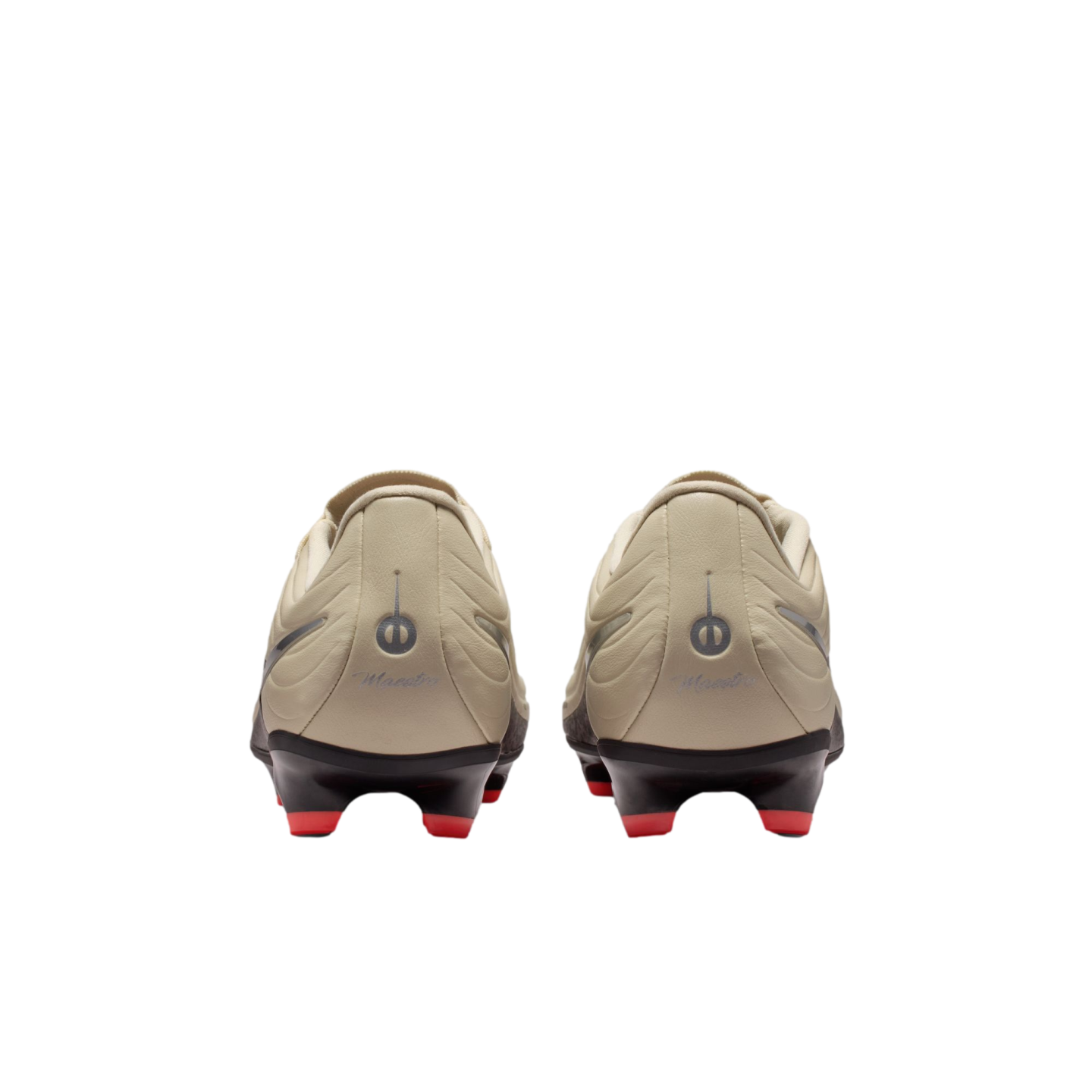 Back view of beige soccer cleats with red studs on a black background. The heels feature a circular logo and "Maestro" script.