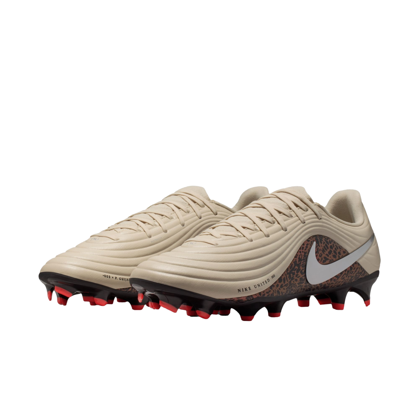 Nike Tiempo Legend 10 soccer cleats in beige with a leopard-print heel and bright orange-tipped studs, set against a black background.