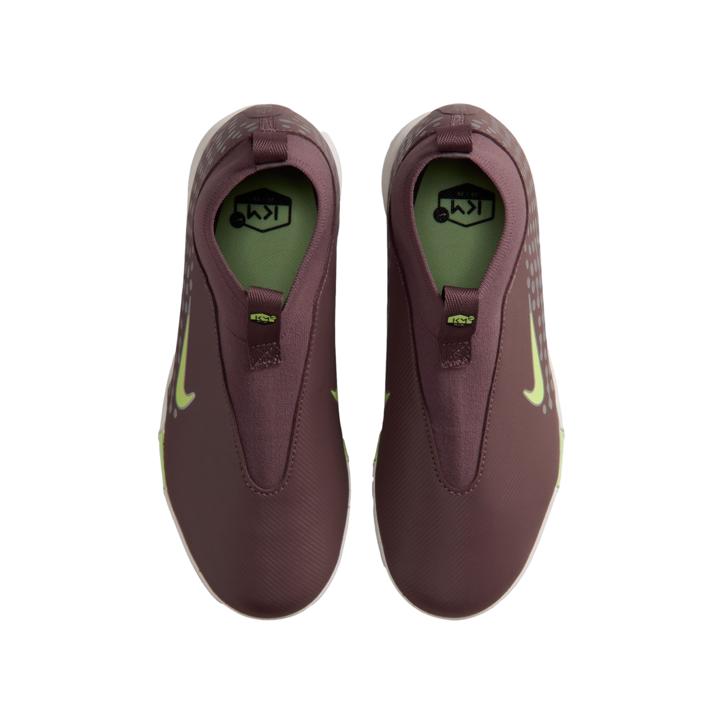 Top-down view of a pair of maroon slip-on Nike shoes featuring lime green swooshes and KM branding on the insoles.