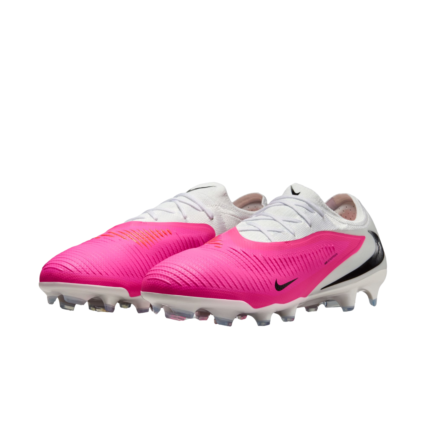 A pair of vibrant pink and white Nike soccer cleats with black swooshes and white studded soles, shown against a white background.