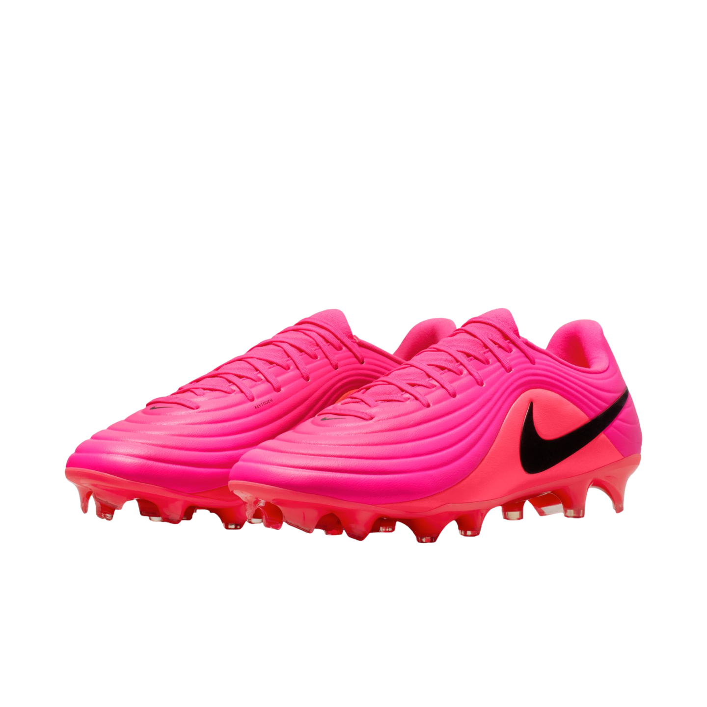 A pair of vibrant pink Nike soccer cleats featuring a ridged, textured upper and a prominent black swoosh on the side, set against a plain white background.