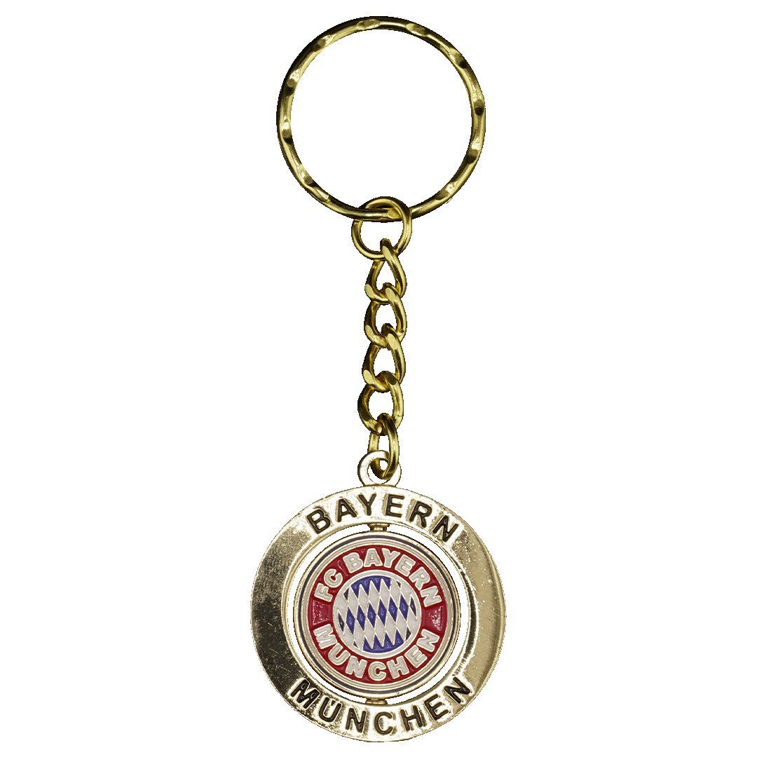 Gold-colored FC Bayern Munich keychain with a circular pendant featuring the team's red, white, and blue logo and "BAYERN MUNCHEN" engraved around the edge.