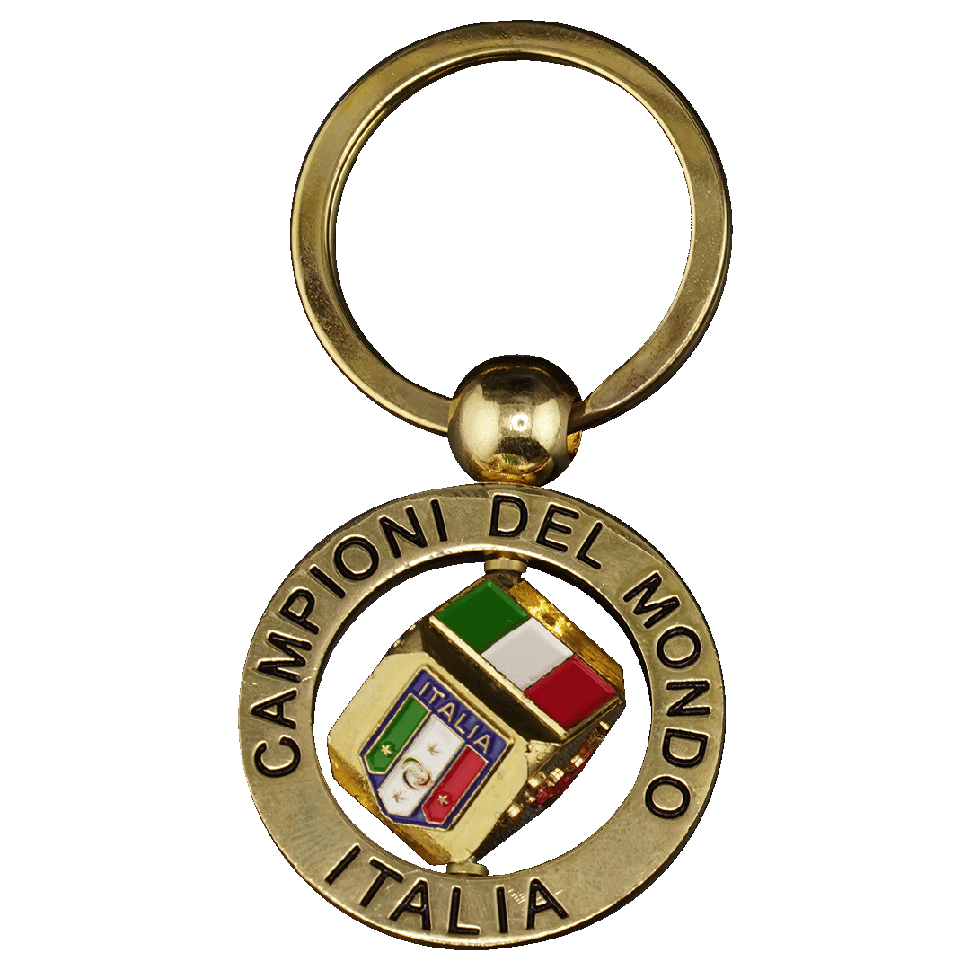 Gold-colored keychain with a circular frame engraved "CAMPIONI DEL MONDO ITALIA." A rotating center piece shows the Italian flag and a team crest with four stars.