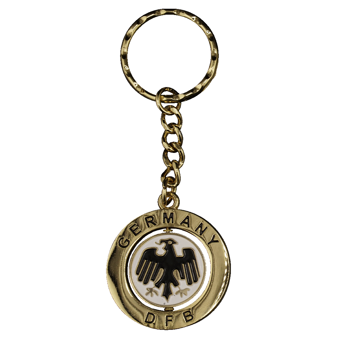 Gold keychain with a circular spinning pendant. The outer ring reads "GERMANY" and "DFB" around a white disc featuring a black eagle logo.