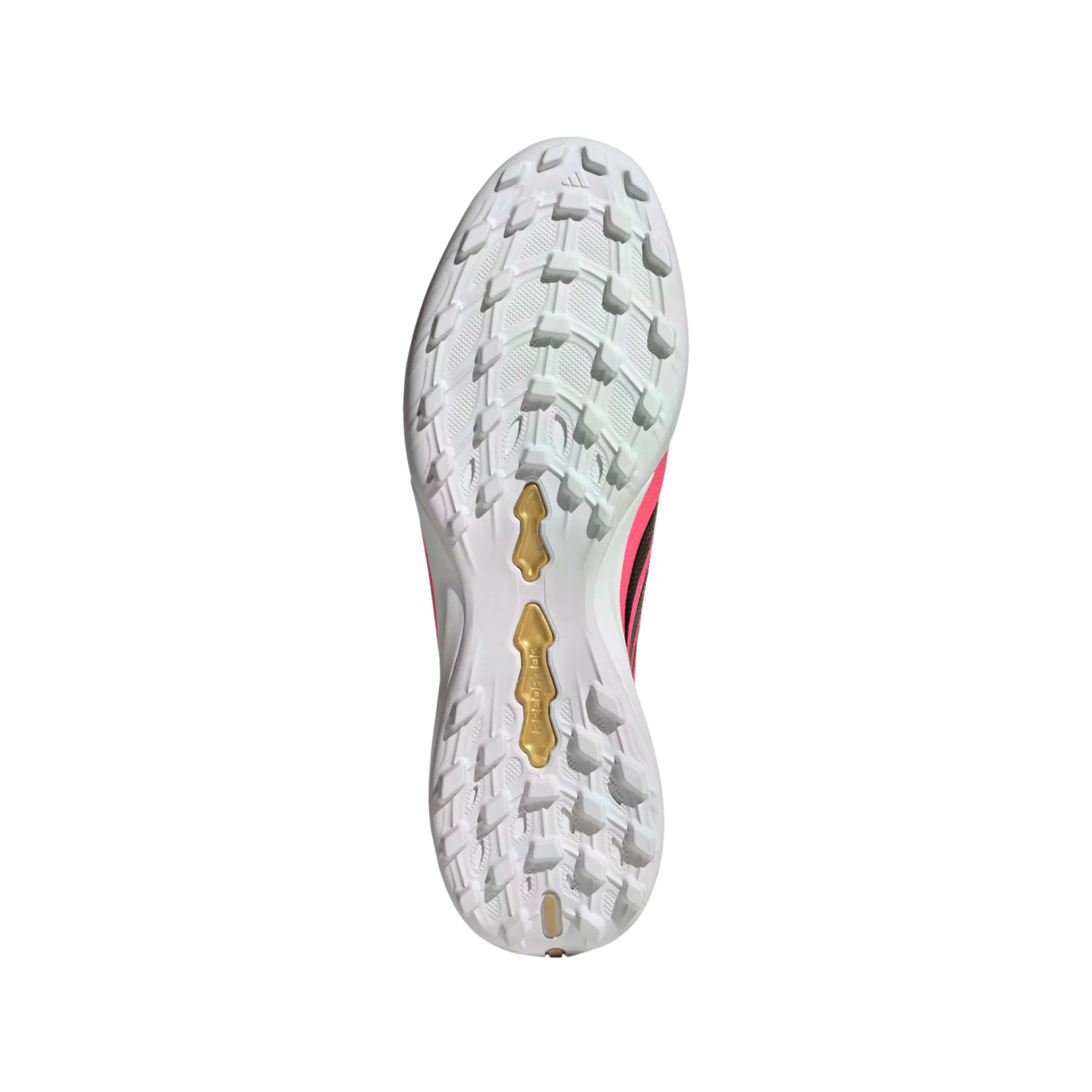 Underside of a white Adidas Predator soccer shoe showing a multi-studded turf outsole with gold plates and pink accents.