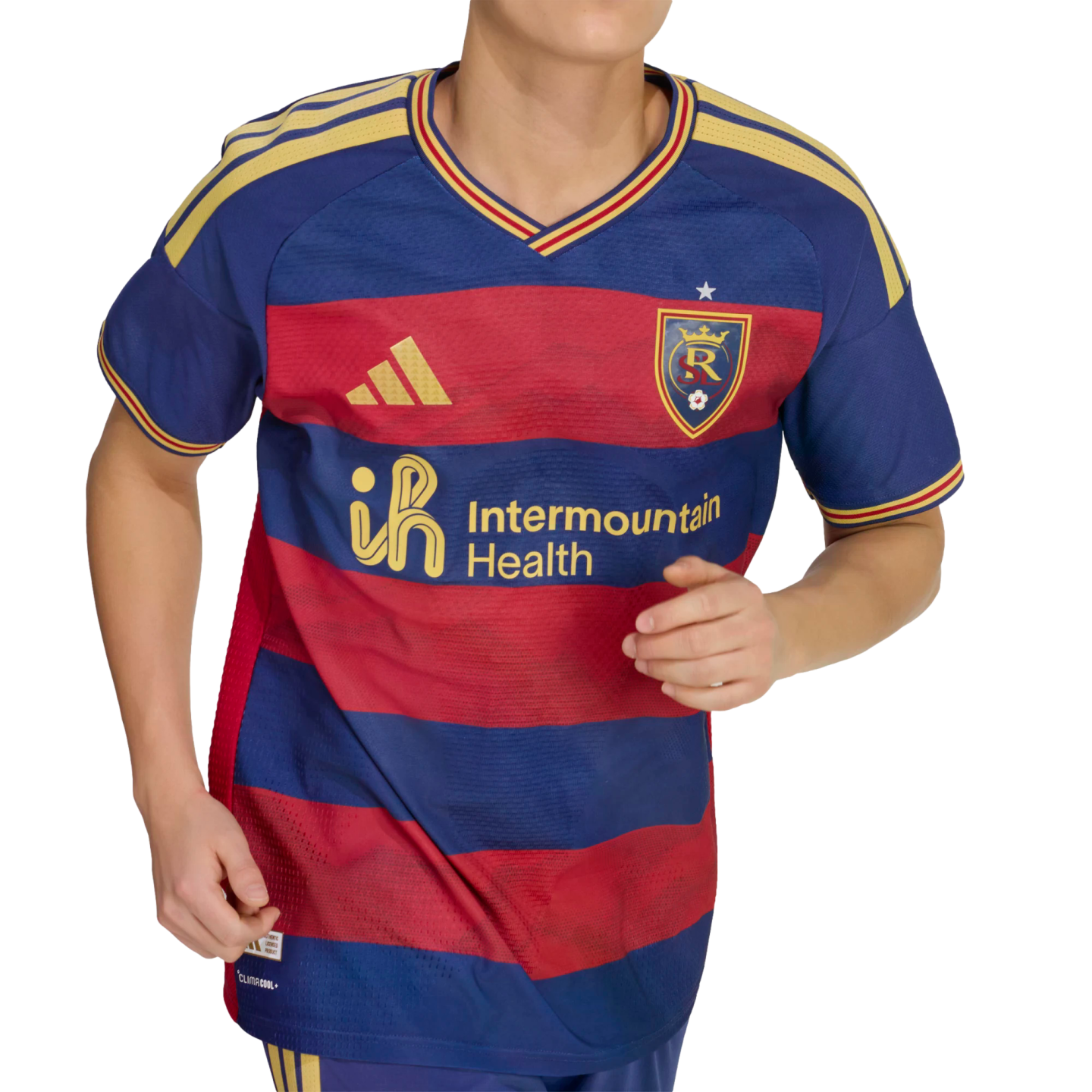 A person wears a blue and red striped soccer jersey featuring gold Adidas and Intermountain Health logos, with yellow shoulder stripes and a team crest.