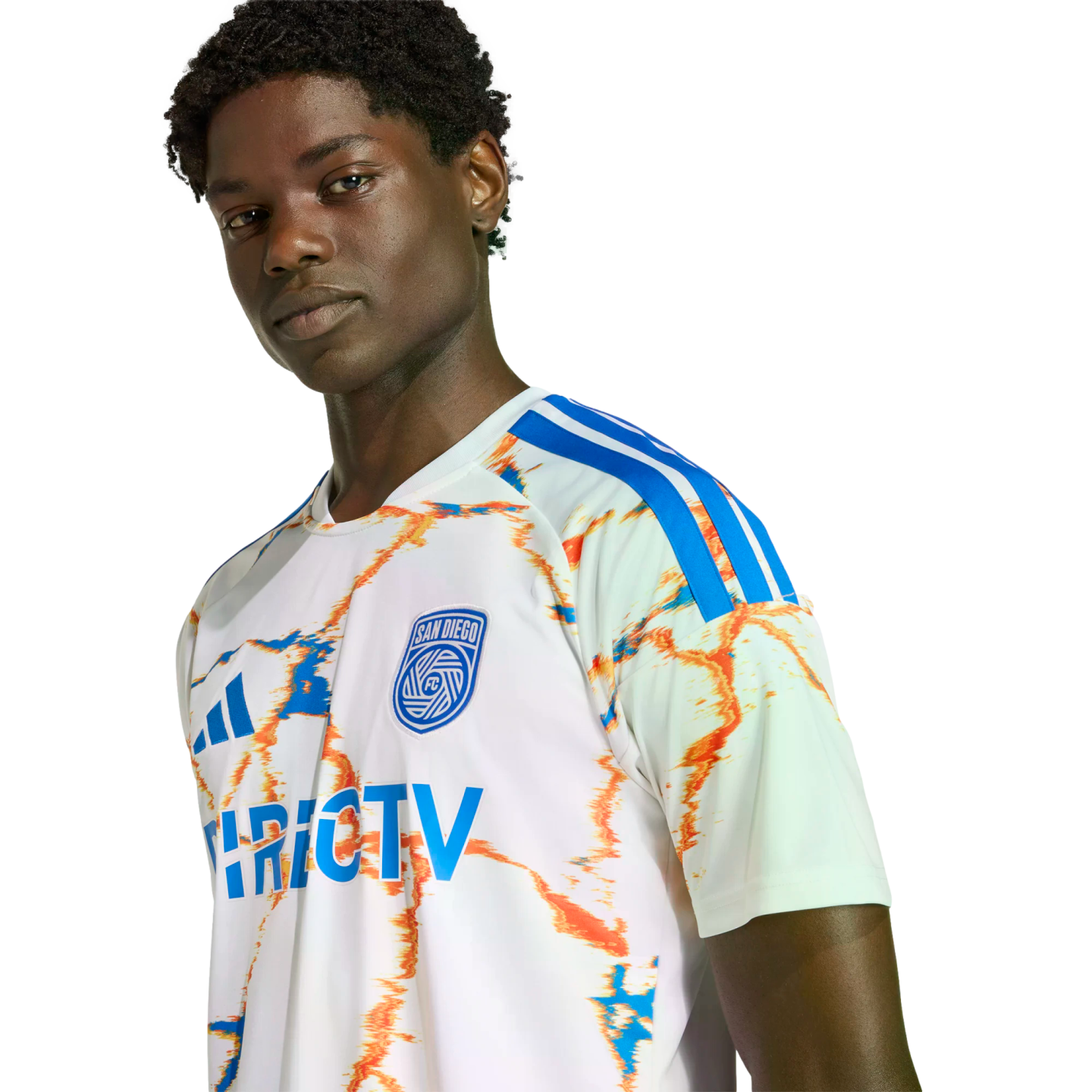 A portrait of a man wearing a white San Diego FC soccer jersey with blue and orange abstract patterns against a black background.