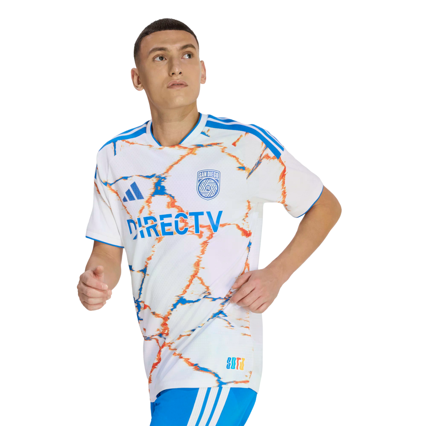 A man wearing a white San Diego FC soccer jersey with blue and orange marble patterns and DirecTV logo, in a running pose against a black background.