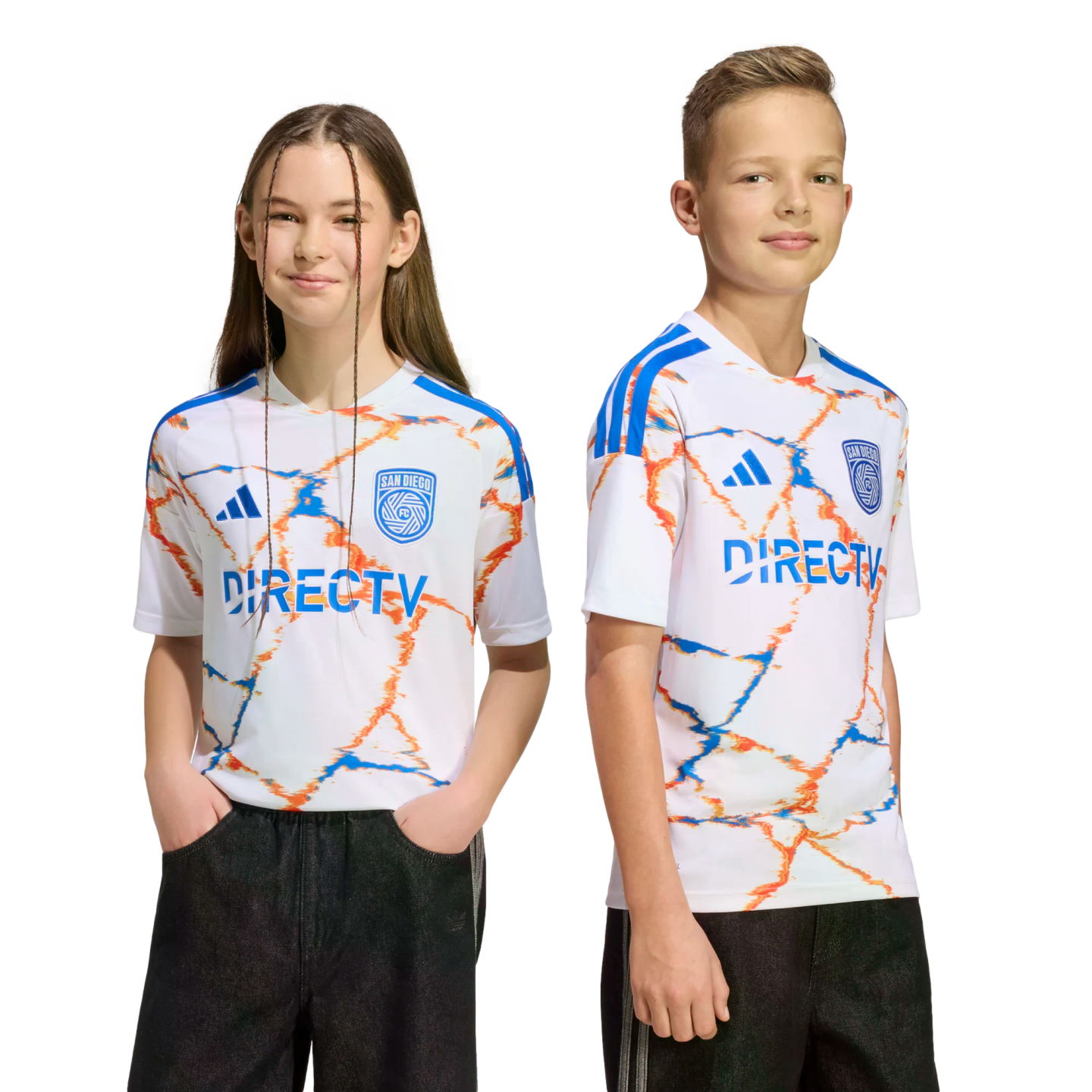 Two youth models wear white San Diego FC soccer jerseys with an orange and blue marbled pattern and the DIRECTV logo. They are posed against a black background.