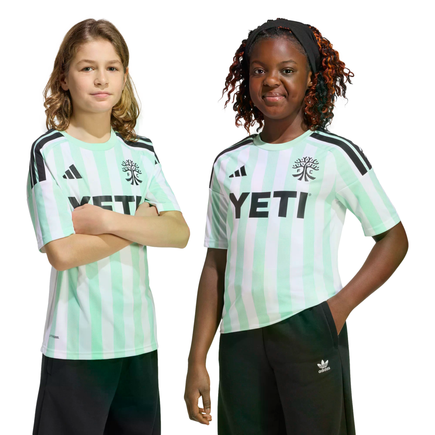 Two children pose in matching mint green and white striped Adidas soccer jerseys with "YETI" branding against a black background.