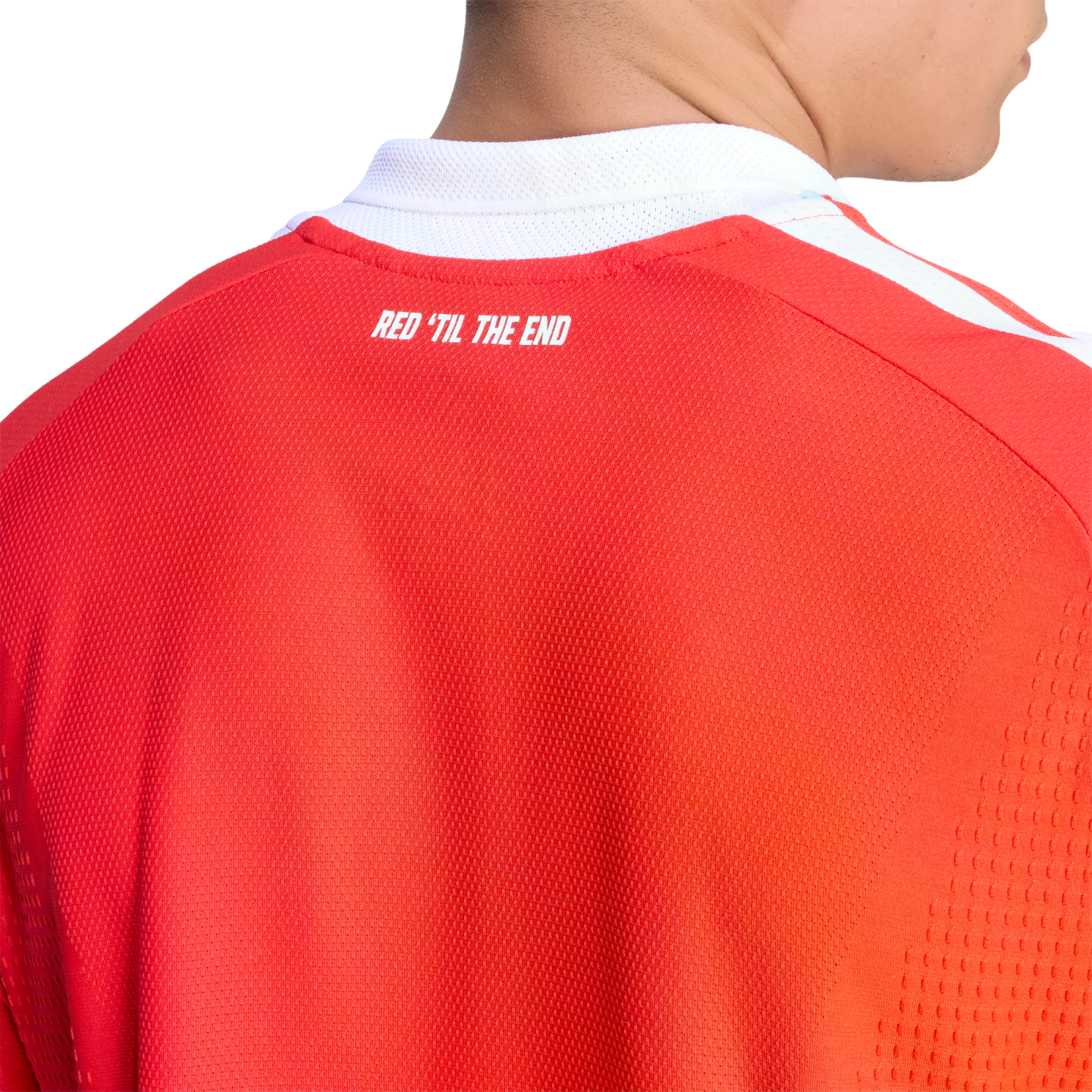 Close-up of the back of a red sports jersey with a white collar. The text "RED 'TIL THE END" is printed in white across the upper back.