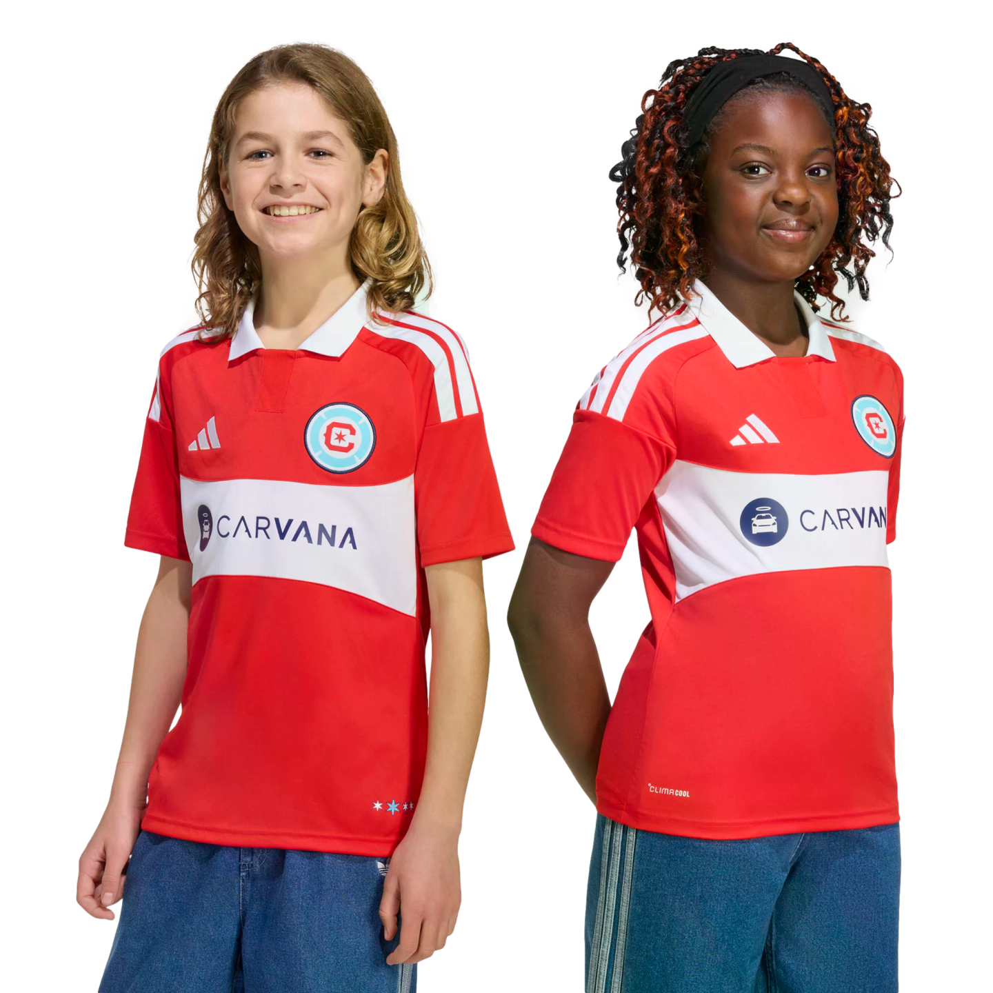 Two smiling children wearing red and white Chicago Fire FC soccer jerseys with the Carvana sponsor logo.
