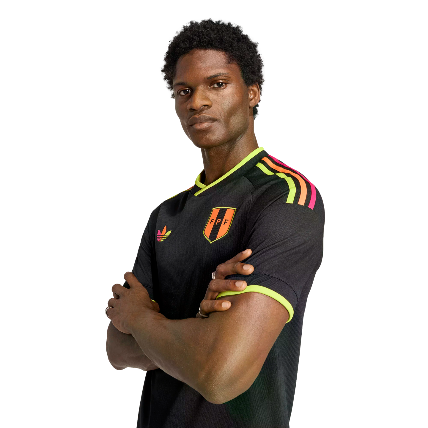 Man with arms crossed wearing a black FPF jersey with neon yellow and orange accents, against a black background.