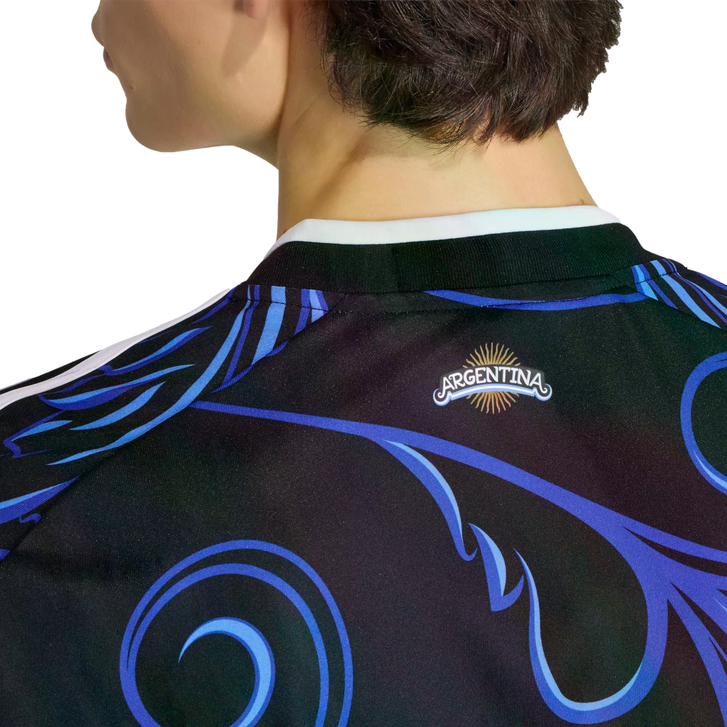 Close-up of the back of a black Argentina soccer jersey featuring vibrant blue and purple swirls and an Argentina sun logo on the neck.