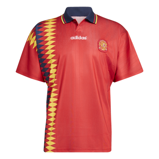 Adidas Spain red soccer jersey with a navy polo collar and a yellow and navy geometric pattern on the right side. Features the Spain national team crest on the chest.