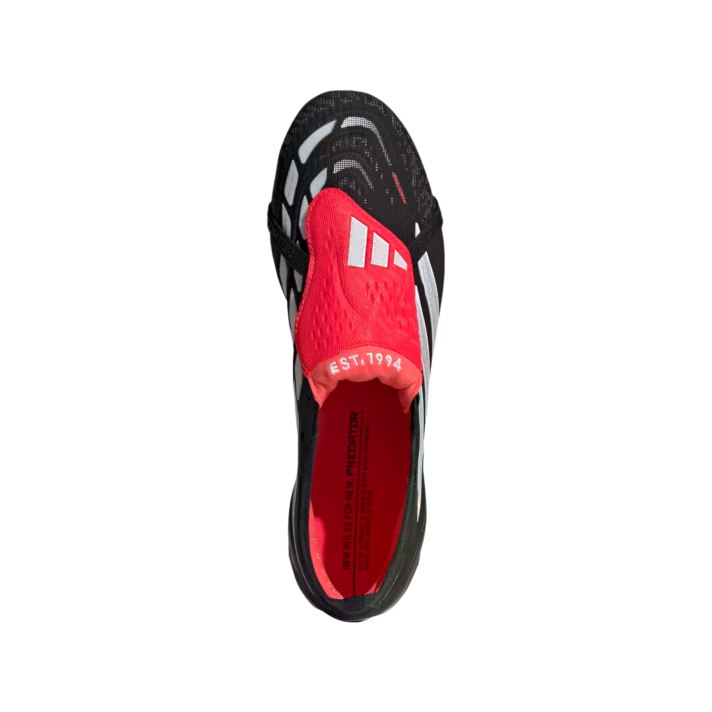 Top-down view of a black Adidas Predator soccer cleat with white stripes and a prominent red fold-over tongue featuring "EST. 1994" text. The interior is bright red.
