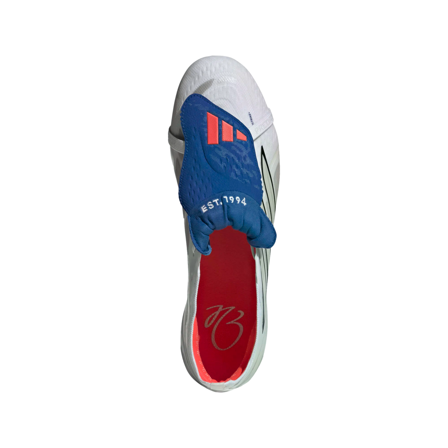 Top-down view of a white Adidas soccer cleat featuring a blue fold-over tongue with red stripes and a red insole with a cursive signature.