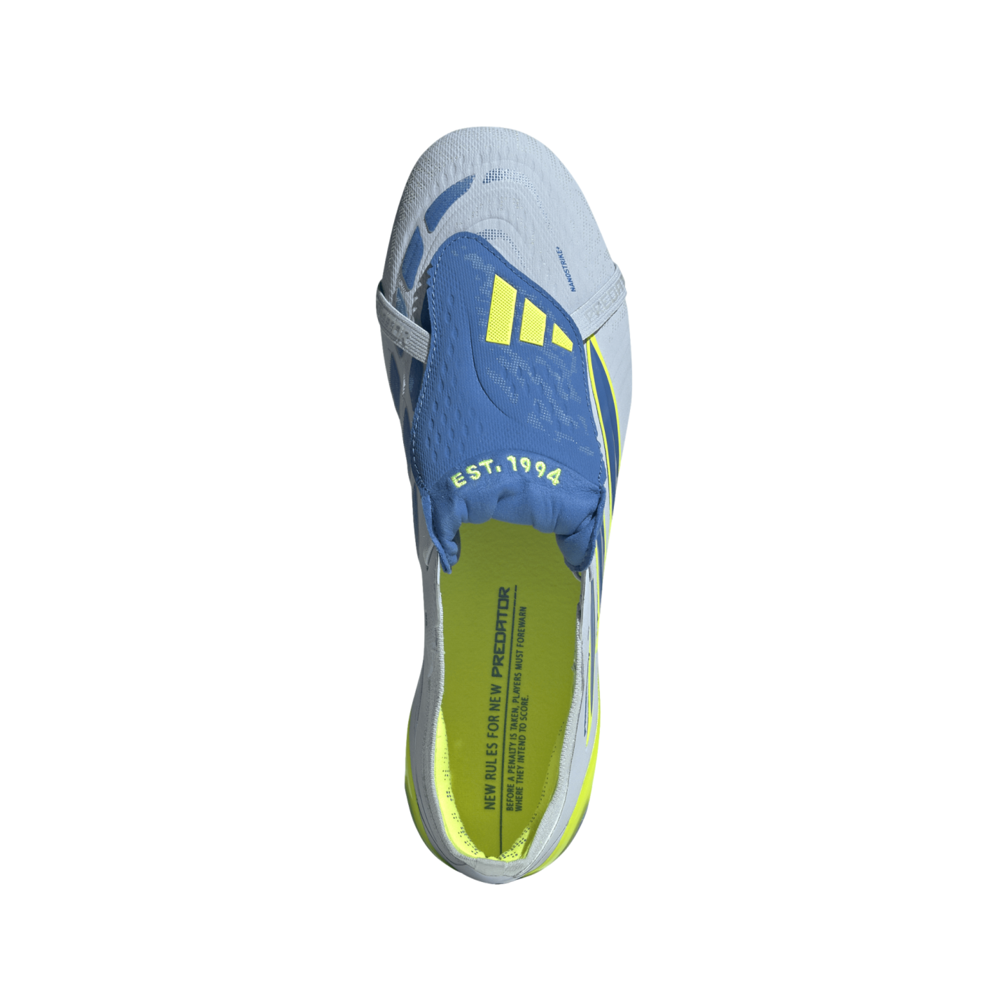 A bird's-eye view of a single Adidas Predator soccer cleat against a solid black background. The shoe is primarily light blue with a royal blue fold-over tongue featuring three yellow stripes and "EST. 1994" in lime green. The interior of the shoe is a vi