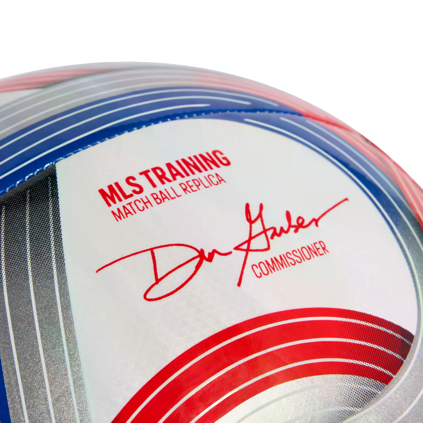 Close-up of an MLS training soccer ball with text reading "MLS TRAINING MATCH BALL REPLICA" and the signature of the league's commissioner.