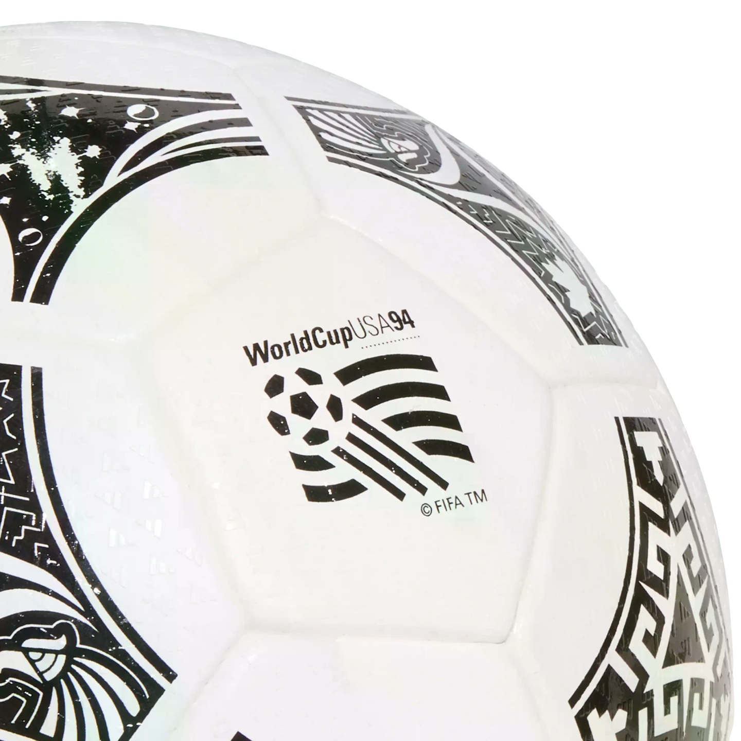 Close-up of a white 1994 World Cup soccer ball featuring black decorative patterns and the tournament logo against a black background.