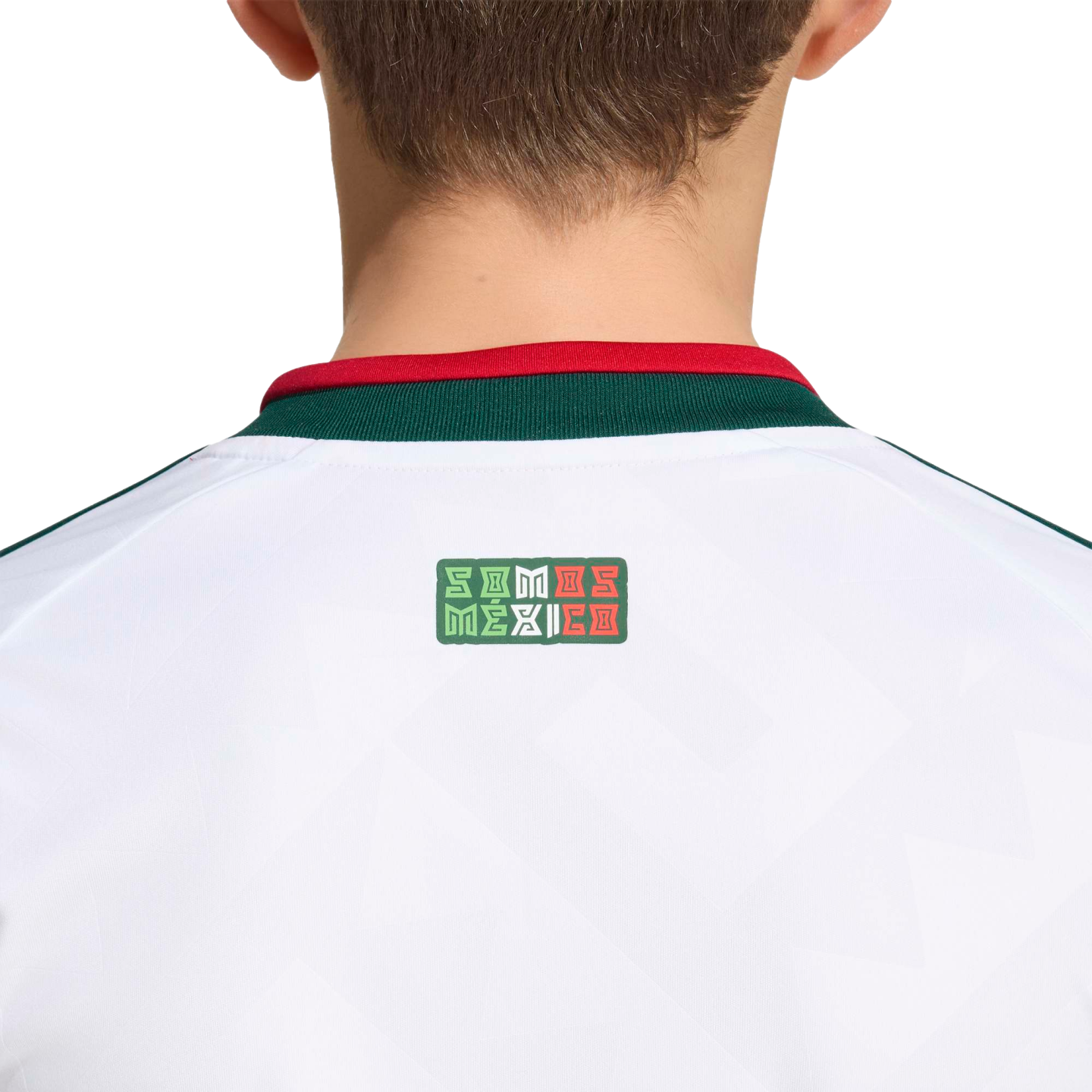 Back view of a white sports jersey with a green and red collar. A small logo below the collar reads "SOMOS MÉXICO" in stylized lettering with the colors of the Mexican flag.