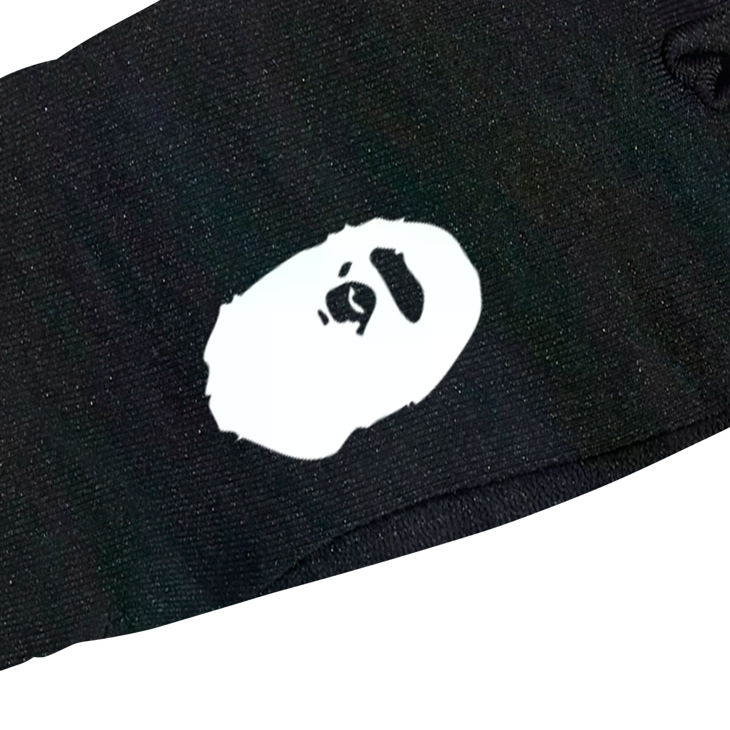 A white BAPE Ape Head logo printed on black fabric.