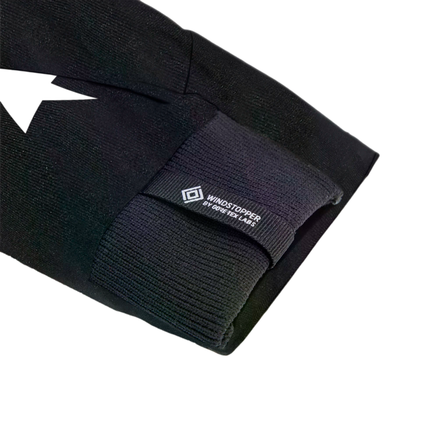Close-up of a black sleeve featuring a ribbed cuff and a small tag with the text "WINDSTOPPER BY GORE-TEX LABS" and a diamond logo.
