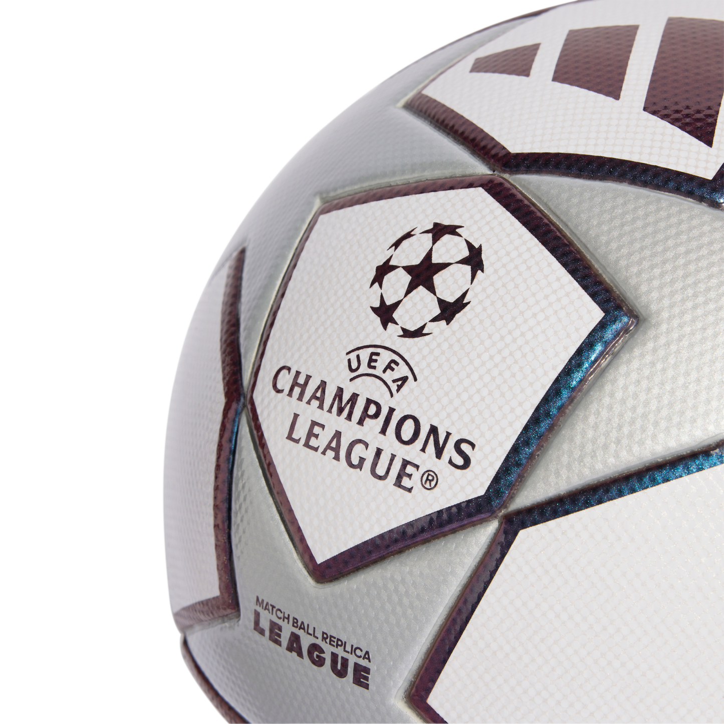 Close-up of a silver and white UEFA Champions League replica soccer ball featuring the official starball logo and textured panels.