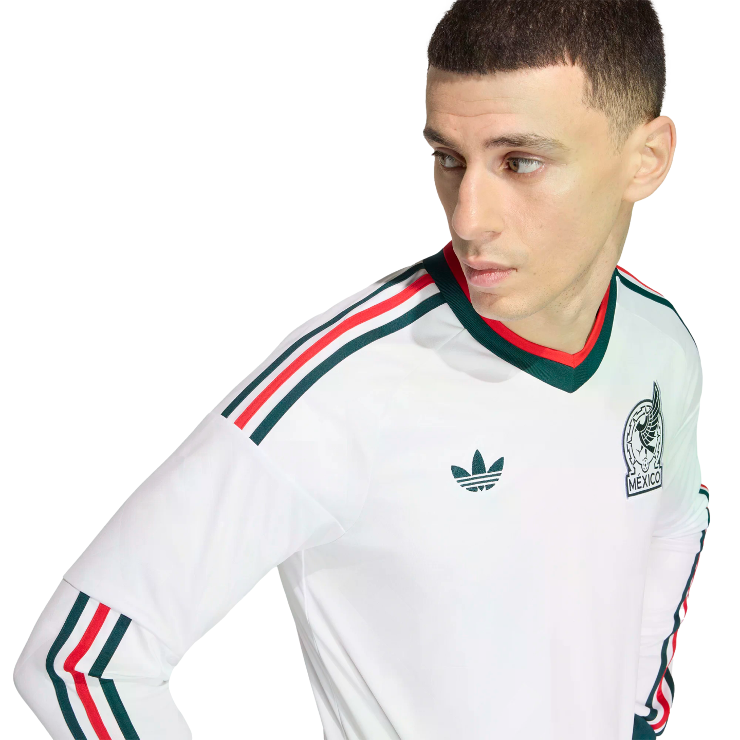 Man wearing a white Mexico national team long-sleeve jersey with green and red stripes and the team crest, posed against a solid black background.