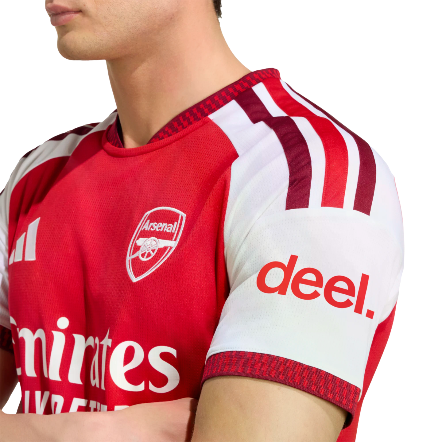 Man wearing a red and white Arsenal FC home jersey with visible club crest and "deel." sleeve sponsor.