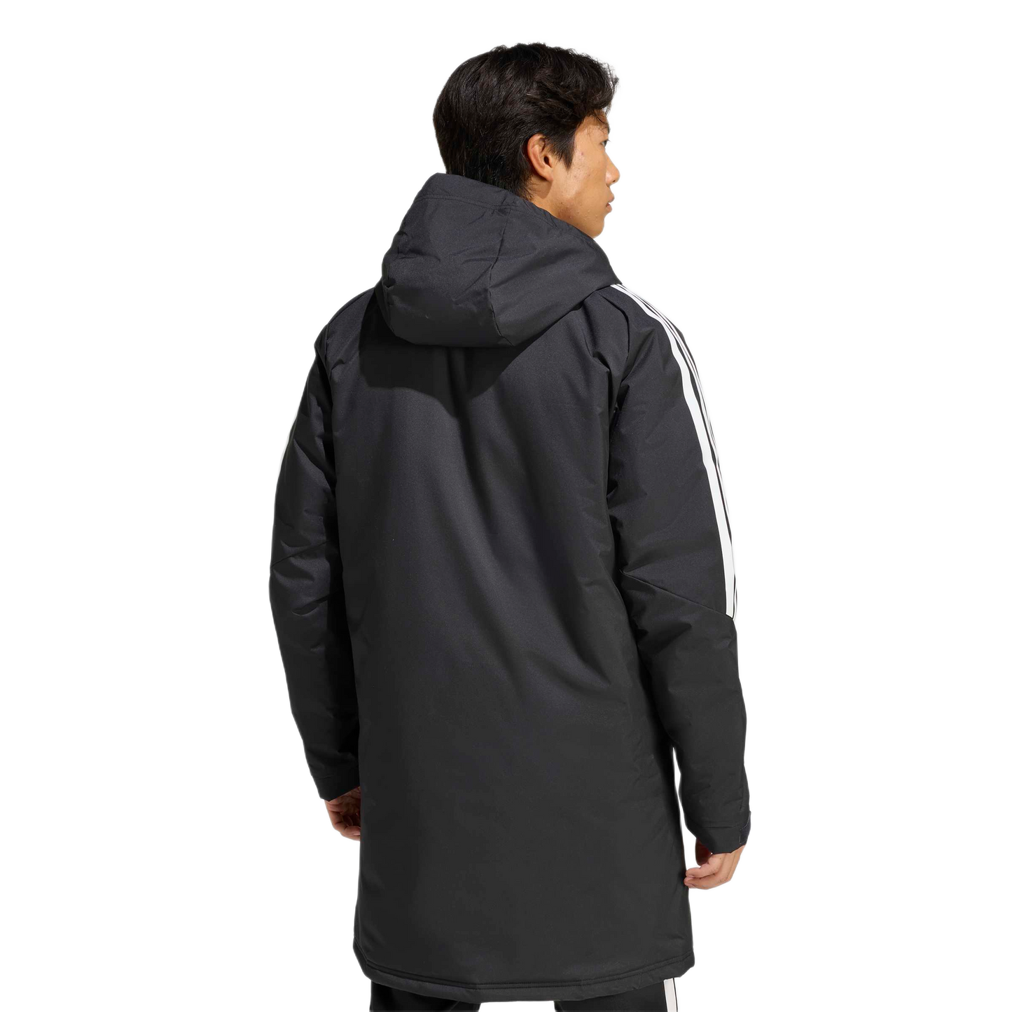 Rear view of a man in a long black hooded parka with white stripes on the sleeves, against a light gray background.