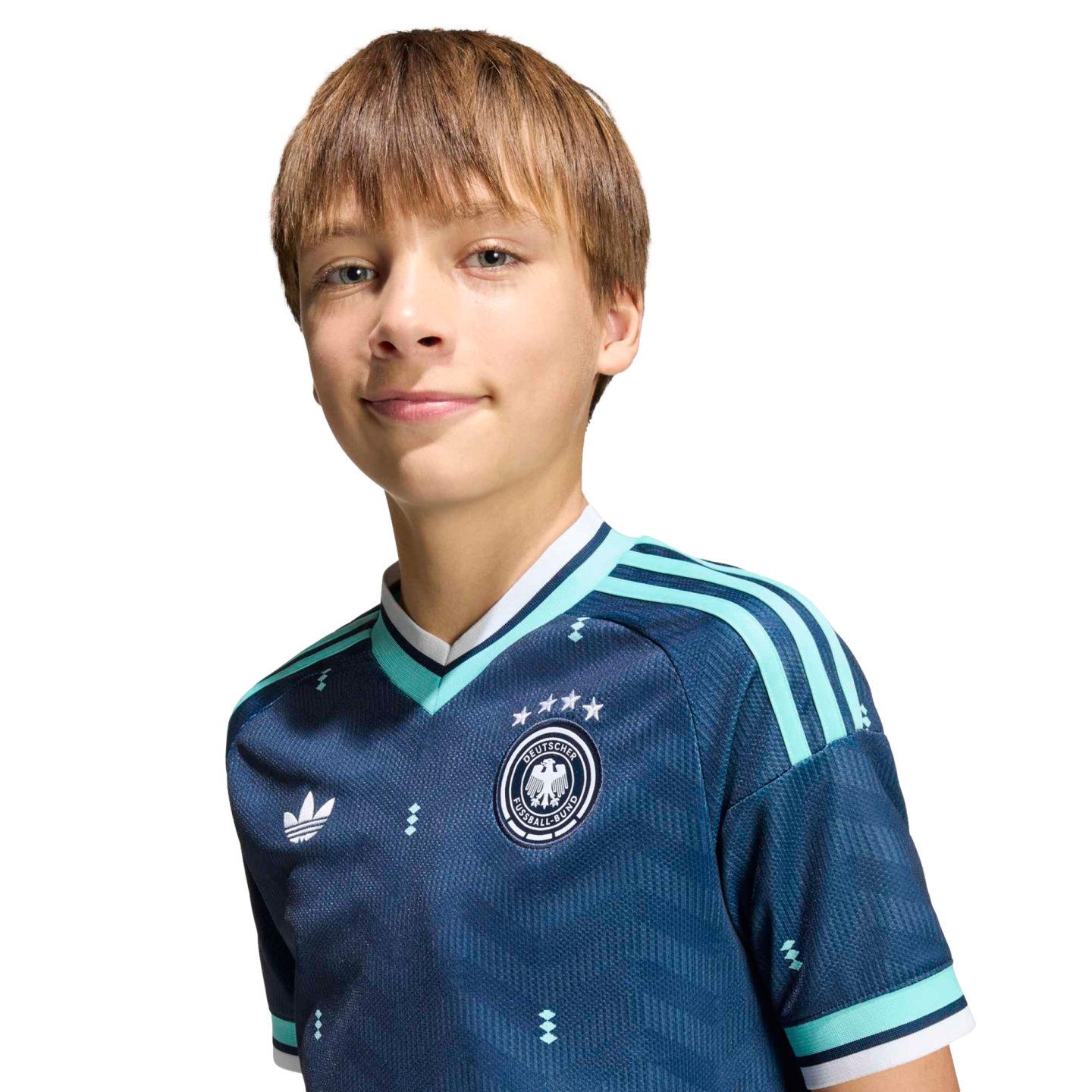 A smiling boy with light brown hair wears a navy blue German soccer jersey with teal stripes and an Adidas logo against a solid black background.
