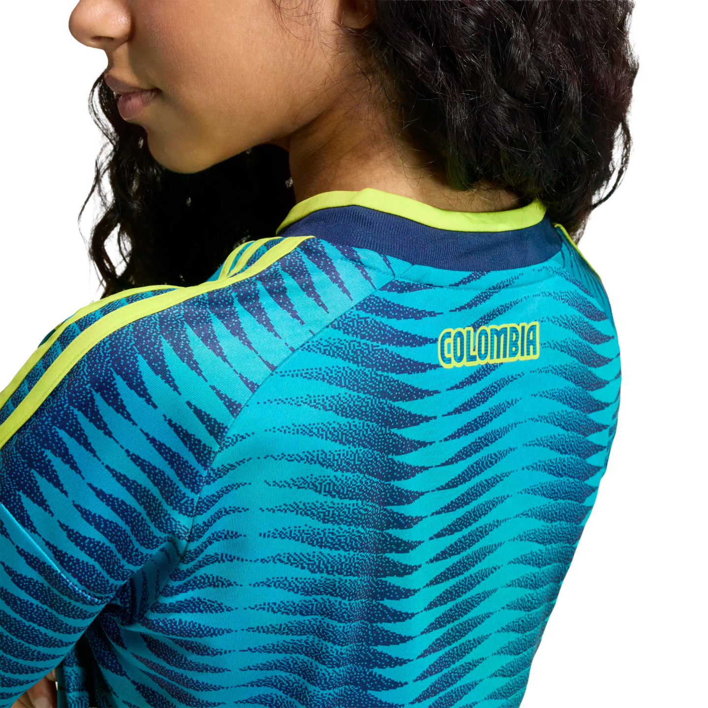 Back view of a person wearing a blue patterned sports jersey with lime green trim and the word "COLOMBIA" printed in yellow on the upper back.