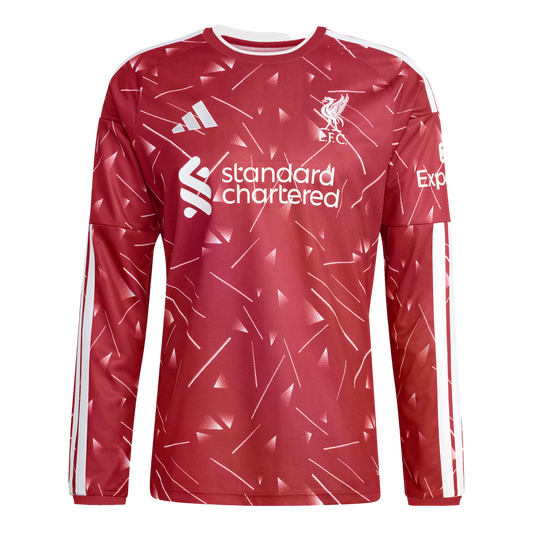 A red long-sleeve Liverpool FC training top with white geometric patterns, Adidas logo, club crest, and Standard Chartered sponsor logo.
