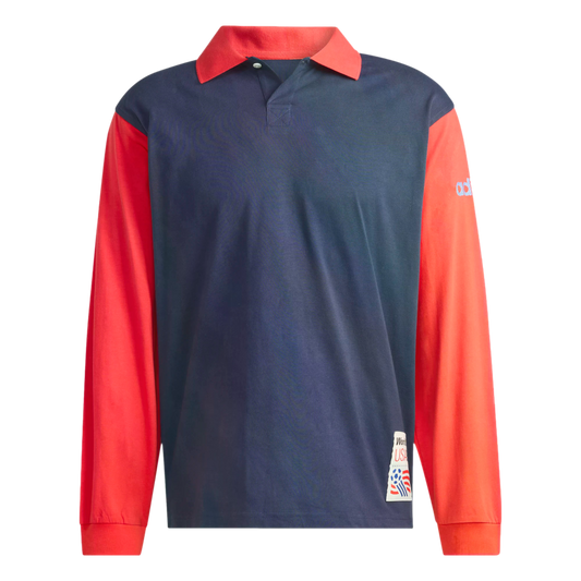 A long-sleeved polo shirt with a navy blue body and contrasting bright red sleeves and collar. The shirt features a World Cup USA 94 patch on the lower front corner and a blue Adidas logo on the upper left sleeve.