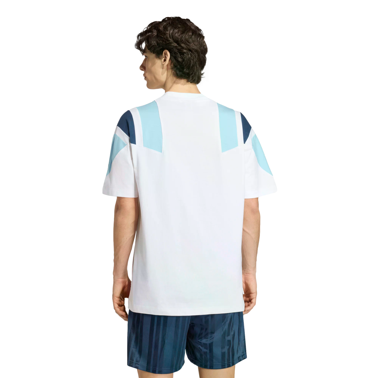 Back view of a man in a white t-shirt with blue geometric shoulder patterns and navy striped shorts against a white background.
