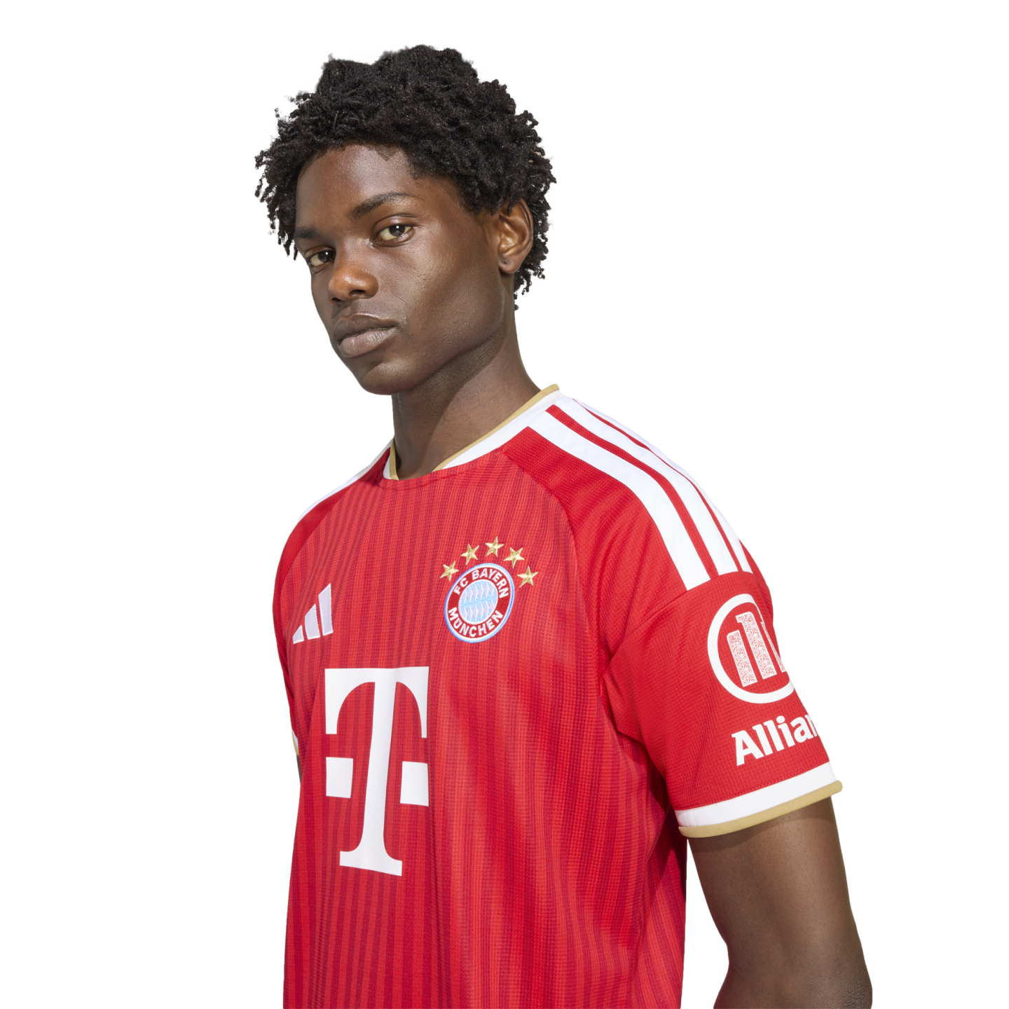 A young man posing in a red FC Bayern Munich soccer jersey with white and gold accents against a plain white background.