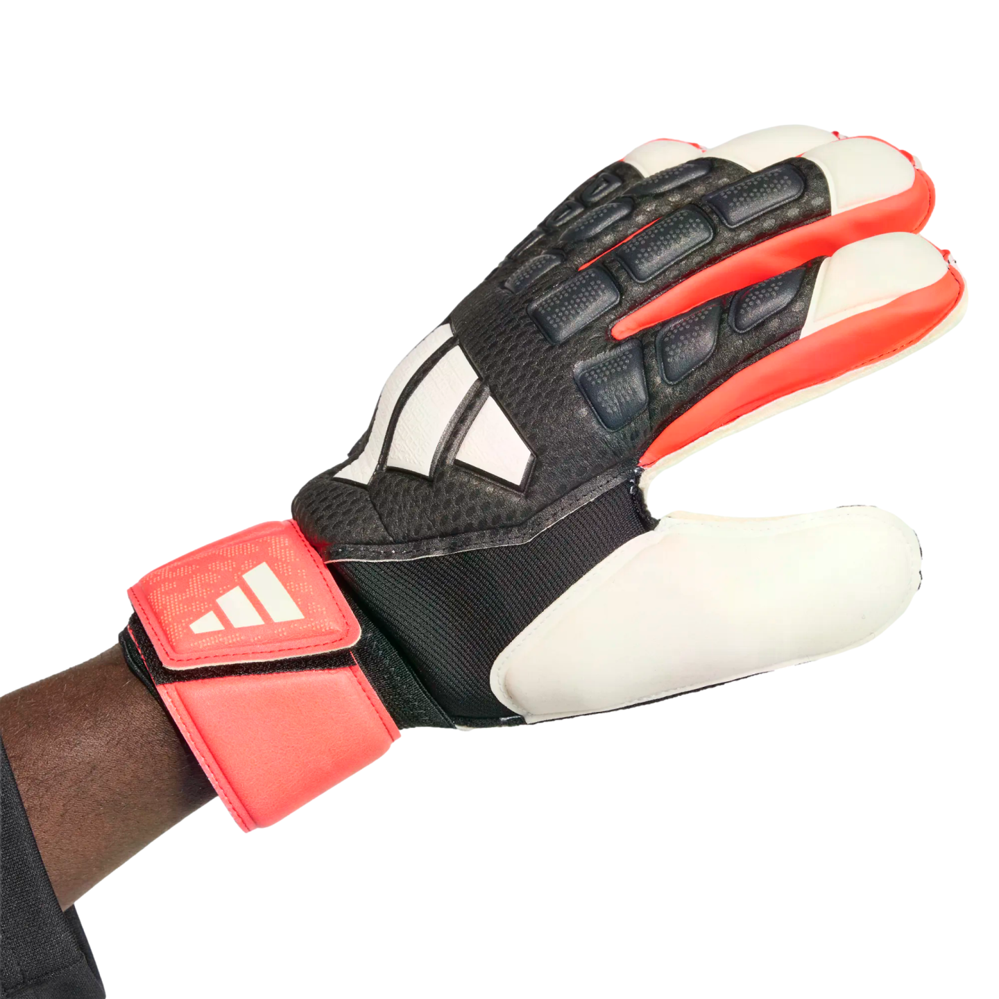 An Adidas goalkeeper glove with a black, white, and red textured design, worn on a hand against a white background.