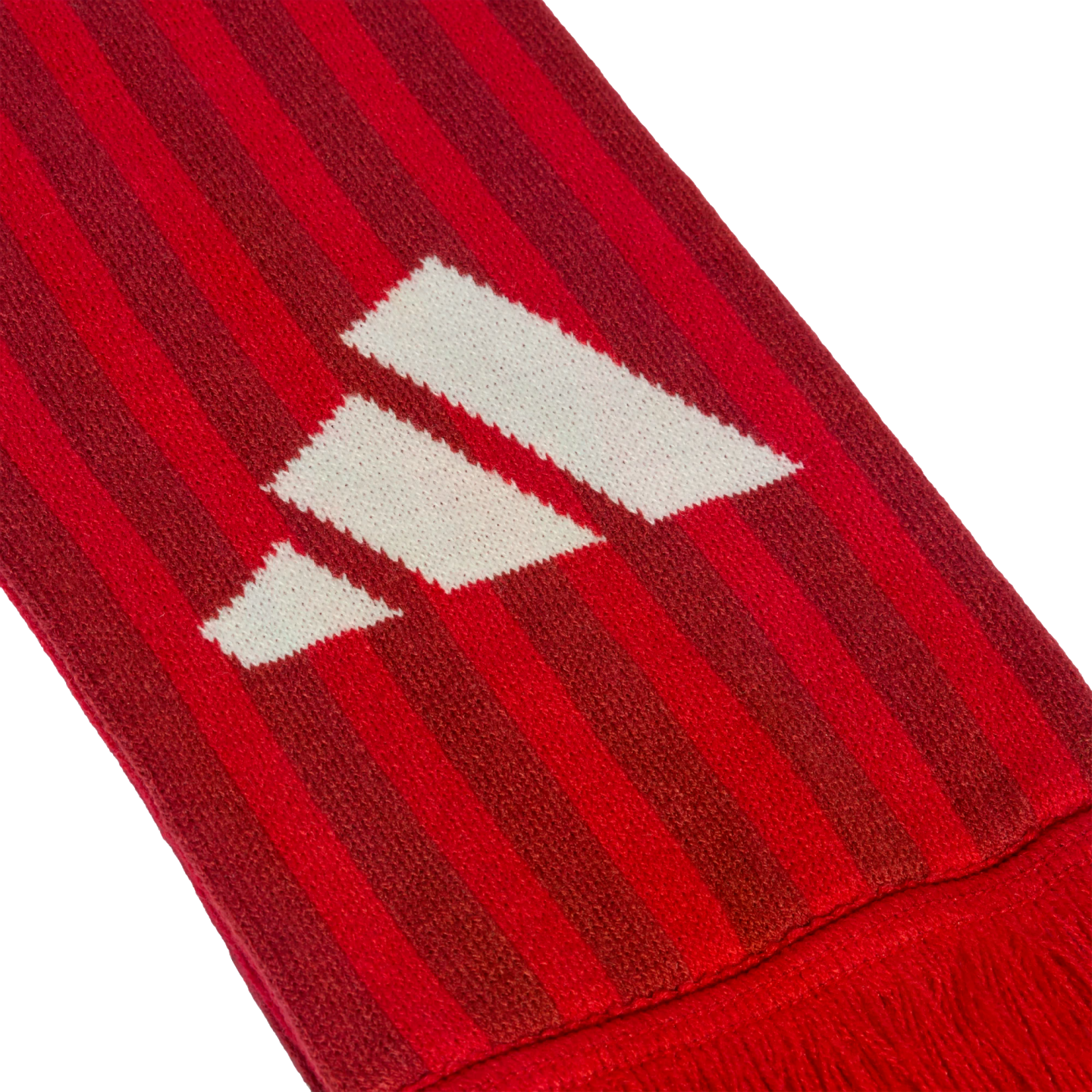 Close-up of a red and dark red striped knitted scarf featuring a white Adidas logo.