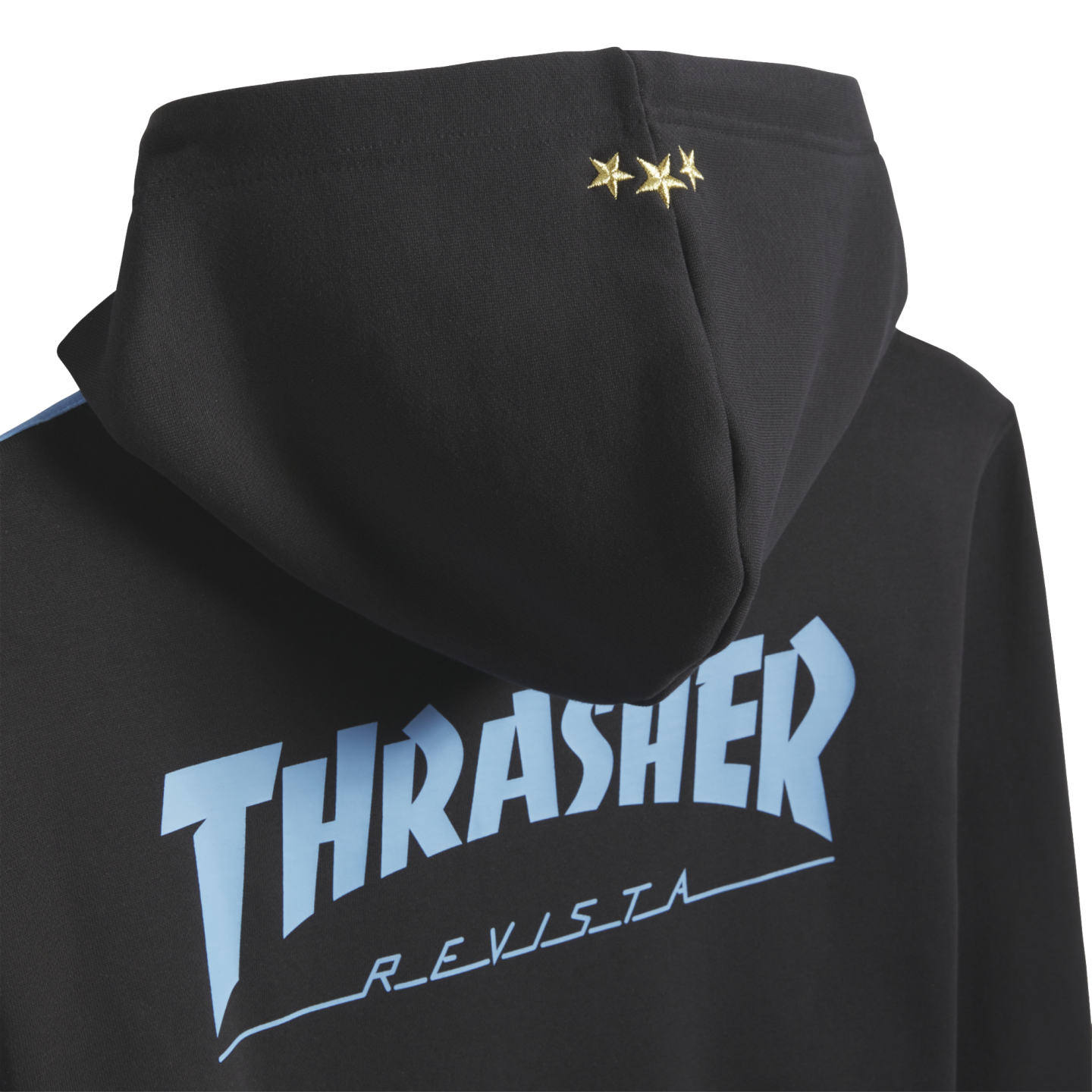 Back of a black hoodie with three gold stars on the hood and light blue "THRASHER REVISTA" text across the back.